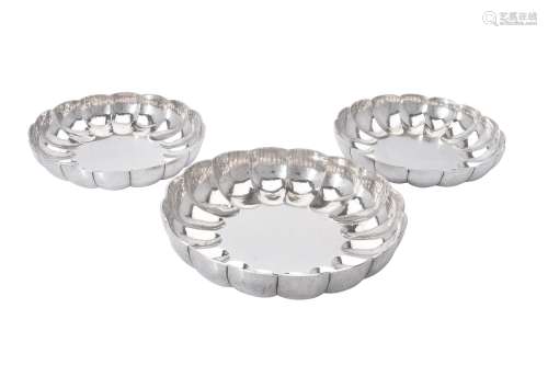 A graduated suite of three shaped circular strawberry dishes...