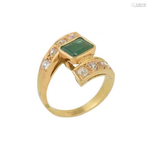 An emerald and diamond crossover ring