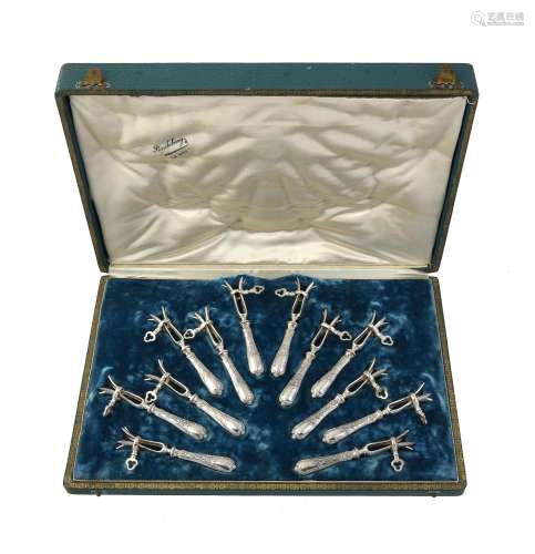 A cased set of twelve French silver lamb shank holders by Lo...