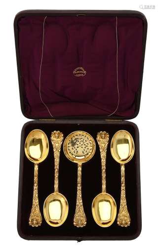 A cased set of four Victorian silver gilt fruit spoons and a...