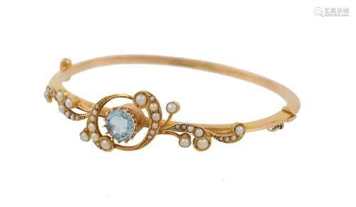 An Edwardian half pearl and aquamarine hinged bangle