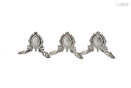 A set of three French silver coloured menu holders