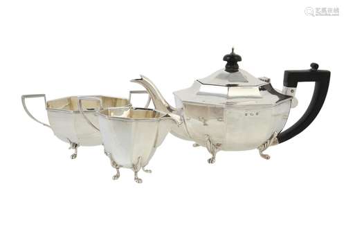 A silver octagonal three piece tea set by Barrett & Thompson