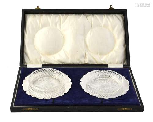 A cased pair of silver shaped circular butter dishes by Geor...