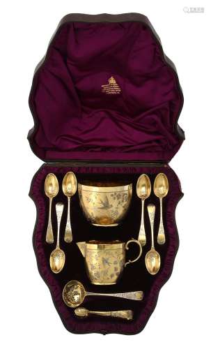 A Victorian silver gilt cream jug, sugar bowl, sifting spoon...