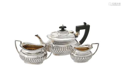 An Edwardian silver oblong baluster three piece tea set by T...