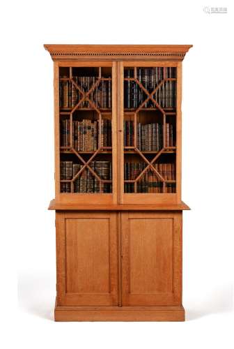 An oak cabinet bookcase, in George III style, probably first...