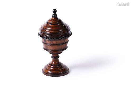 A turned yew and ebonised urn and cover, English or Dutch, 1...