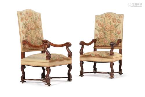 A pair of walnut and tapestry upholstered open armchairs, in...