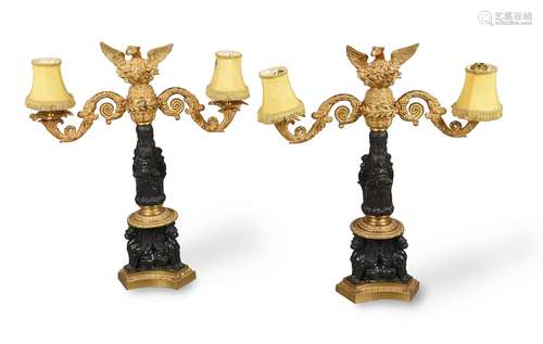 A pair of patinated and parcel gilt bronze twin branch cande...