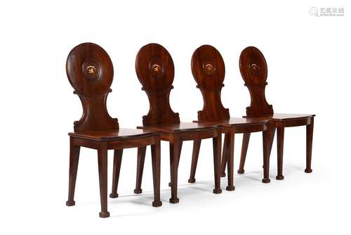 A set of four George III mahogany hall chairs