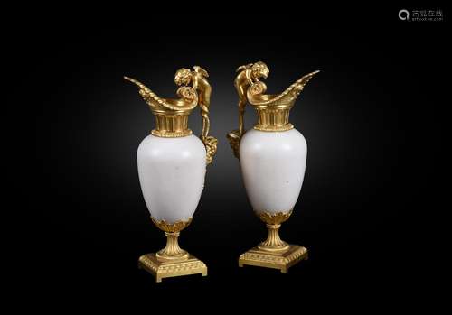 A pair of French white marble and gilt bronze mounted ewers ...