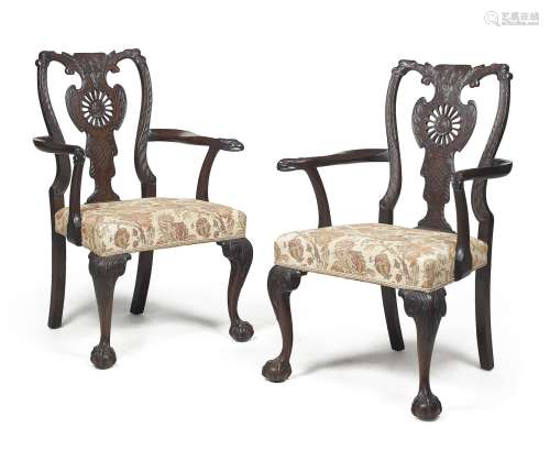 A pair of carved mahogany armchairs, in George II style, 19t...
