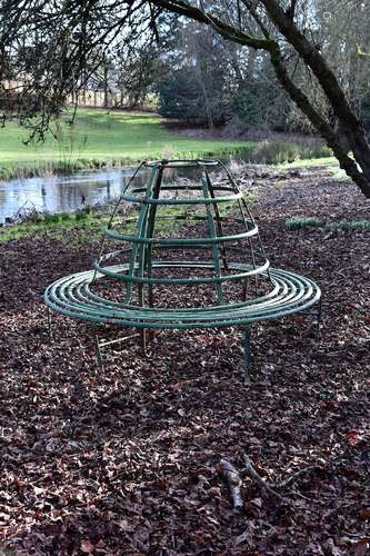 A large Regency green painted wrought iron circular garden o...