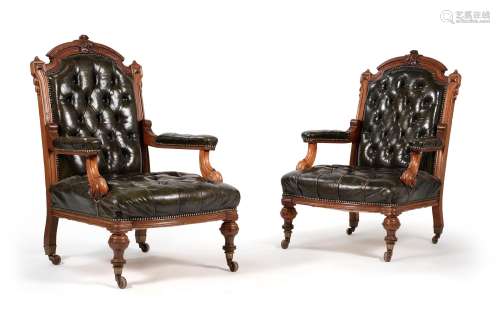 A pair of Victorian walnut and leather upholstered library a...
