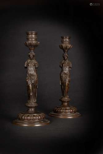 A pair of Regency patinated bronze figural candlesticks, cir...