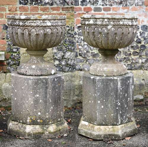 A pair of English garden urns on plinths in Gothic Revival s...