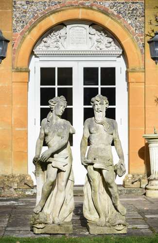 A pair of carved stone garden models of Neptune and Amphitri...