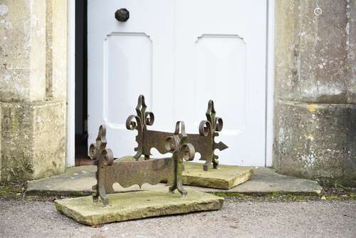 A pair of English limestone and wrought iron mounted bootscr...