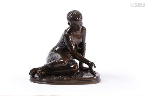 A French patinated bronze model of a young girl playing with...