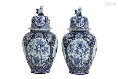 A PAIR OF LATE 19TH CENTURY DELFT POTTERY URNS BY PETRUS REG...