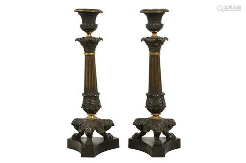 A PAIR OF REGENCY BRONZE AND PARCEL GILT CANDLESTICKS