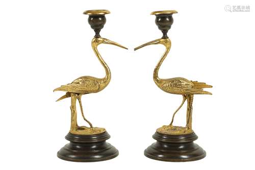 A PAIR OF GILT AND PATINATED BRONZE STORK CANDLESTICKS IN TH...