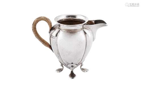 An Edwardian 'Arts and Crafts' sterling silver cream jug, Lo...