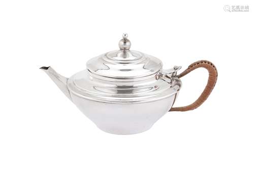 A George V ‘Arts and Crafts’ sterling silver green tea teapo...