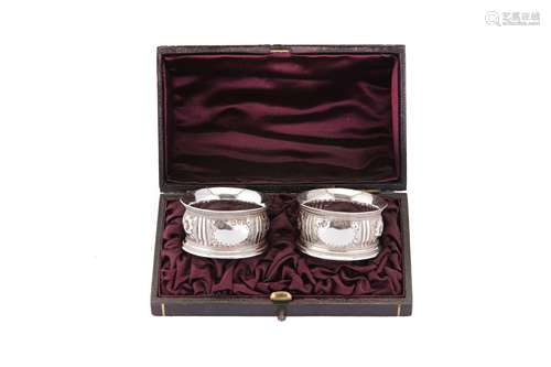 A cased pair of Victorian sterling silver napkin rings, Lond...