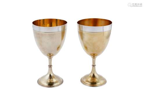 A pair of large Victorian sterling silver parcel gilt goblet...