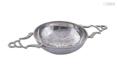 An early 18th century unmarked silver lemon strainer, probab...