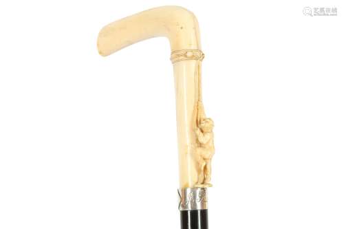 A CARVED MARINE IVORY HANDLED WALKING CANE, LATE 19TH TO EAR...