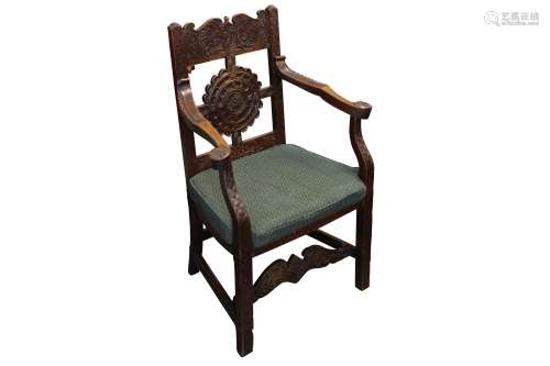 A CARVED OAK OPEN ARMCHAIR, STAMPED W. HUGHES, 20TH CENTURY