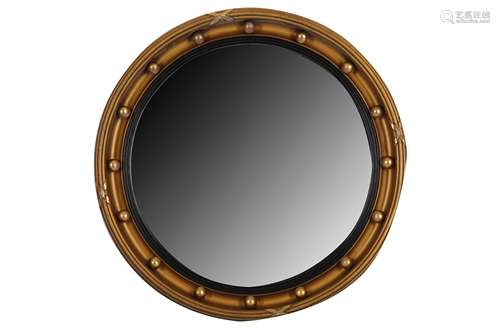 AN EARLY 20TH CENTURY REGENCY STYLE CIRCULAR MIRROR