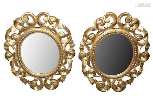 A PAIR OF ITALIAN FLORENTINE FRAME OVAL GILT WOOD MIRRORS, L...