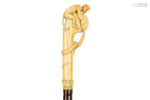 A NAIVE CARVED IVORY HANDLED WALKING CANE, EARLY 20TH CENTUR...