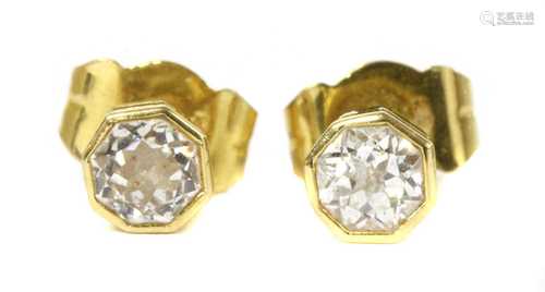 A pair of 18ct gold single stone diamond stud earrings,