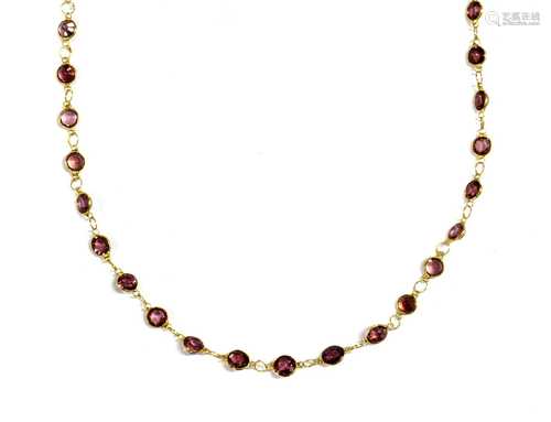 A gold garnet rivière necklace,