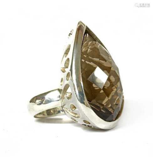 A large silver single stone smoky quartz ring,