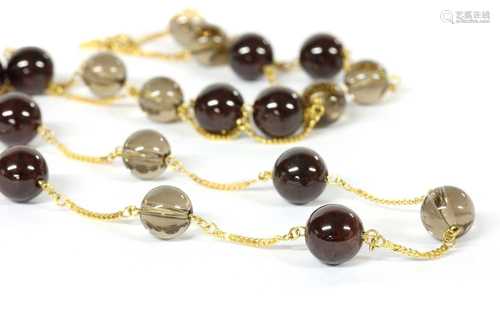 A gold garnet and smoky quartz necklace,