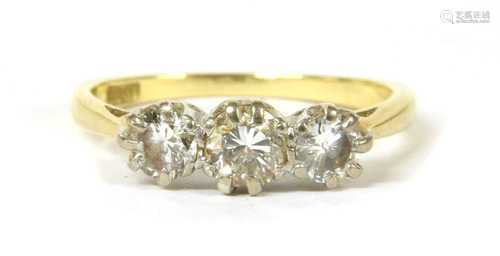 A gold three stone diamond ring,