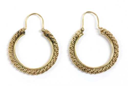 A pair of gold hoop earrings,