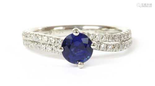 A platinum single stone sapphire crossover ring,