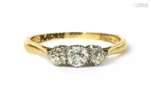 A gold three stone diamond ring,