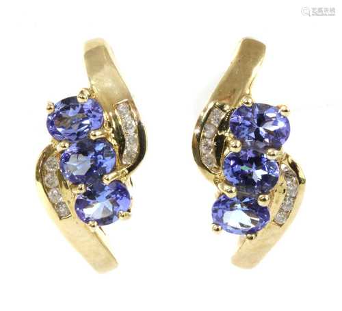 A pair of gold tanzanite and diamond stud earrings,