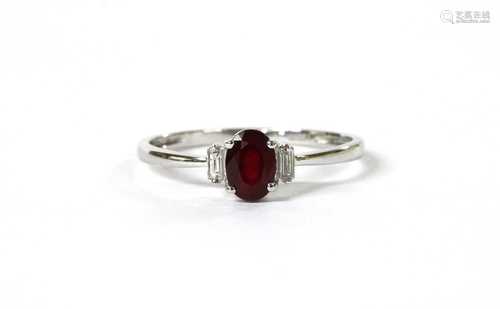 A white gold three stone ruby and diamond ring,