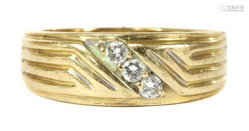 A gold three stone diamond ring,