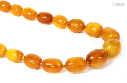 A single row graduated amber bead necklace,