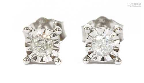 A pair of white gold single stone diamond stud earrings,